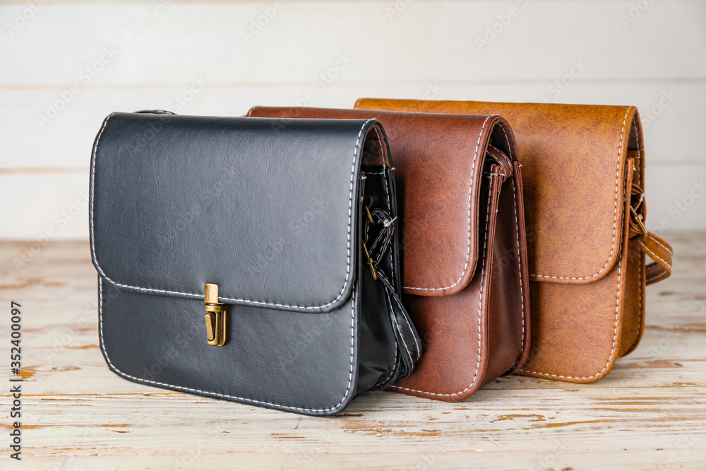 Stylish female bags on table