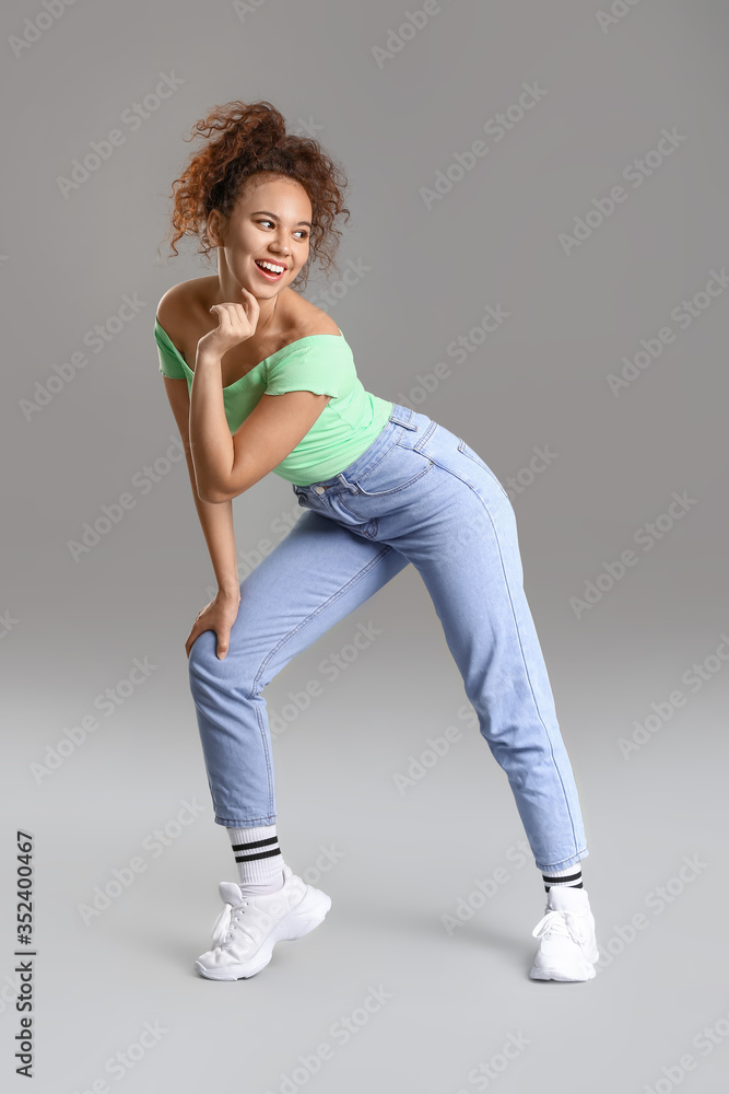 African-American hip-hop dancer on grey background