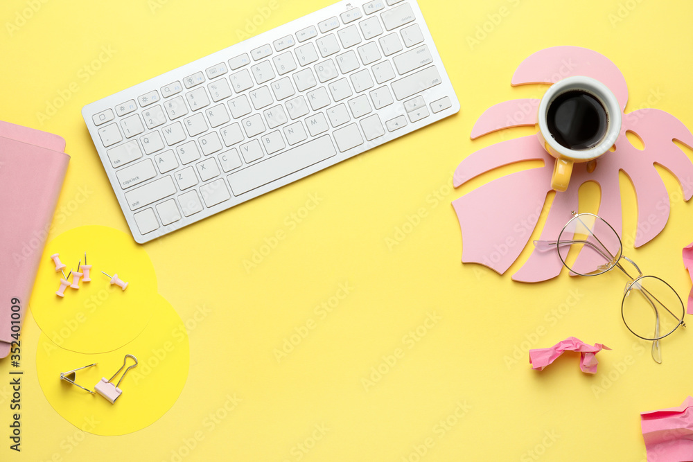 Computer keyboard with cup of coffee, eyeglasses and stationery on color background - obrazy, fototapety, plakaty 