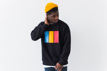 Wall Mural - Youth street fashion concept - Portrait of confident sexy black man in stylish sweatshirt on white background.