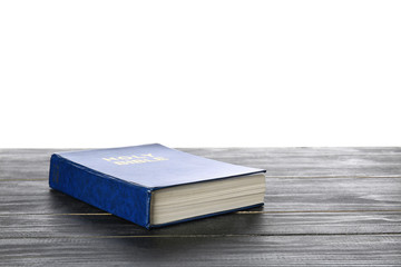 Holy Bible on table against white background