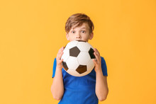 Cute Little Boy With Soccer Ball On Color Background