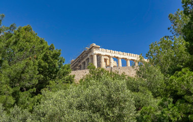 partial view of Parthenon temple on Acropolis of Athens under clear blue sky , Greece