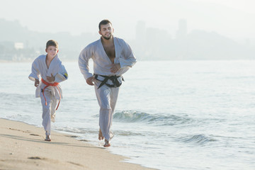 Wall Mural - Man and boy exercising karate