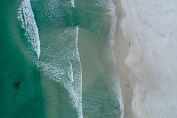 aerial zenithal photo of beach with blue-green sea