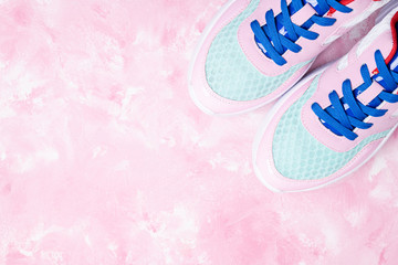 Sport and healthy lifestyle concept. Sport shoes on pink background. Sport clothing. Fashionable feminine sportwear for fitness and yoga. Copy space