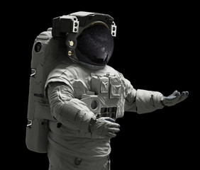 Wall Mural - astronaut presenting an empty space isolated on black background