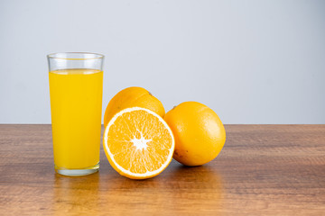 glass of orange juice and orange