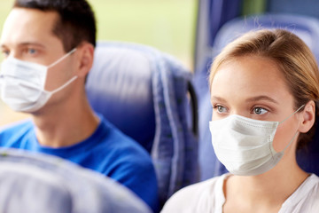 Sticker - tourism, healthcare and pandemic concept - young woman wearing face protective medical mask for protection from virus disease sitting in travel bus or train