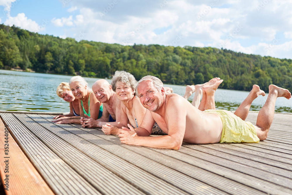 Retired seniors relax at the lake - obrazy, fototapety, plakaty 