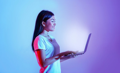 Online work and education. Girl holding laptop with glowing screen