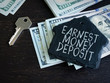 Earnest Money Deposit label and stack of money.