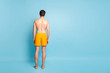 © deagreez - Full length body size rear back behind view of his he nice attractive young guy in swimming shorts spending vacation isolated on bright vivid shine vibrant green blue turquoise color background