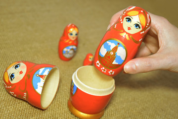 girl's hand close up make up a matryoshka