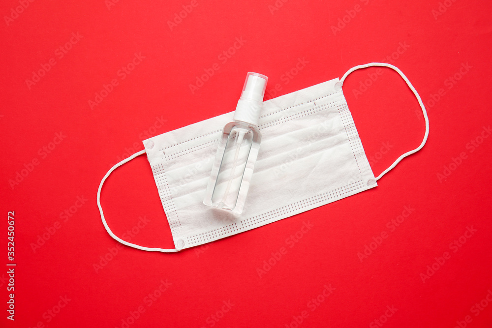 Disinfectant and medical mask on color background - obrazy, fototapety, plakaty 