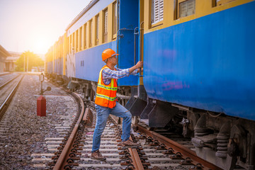 Wall Mural - Portrait engineer under inspection and checking construction process railway switch and checking work on railroad station .Engineer used radio communication and safety helmet in work.