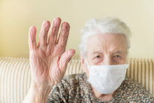 Old Woman With Health Mask Making Stop Sign With Wrinkled Hand
