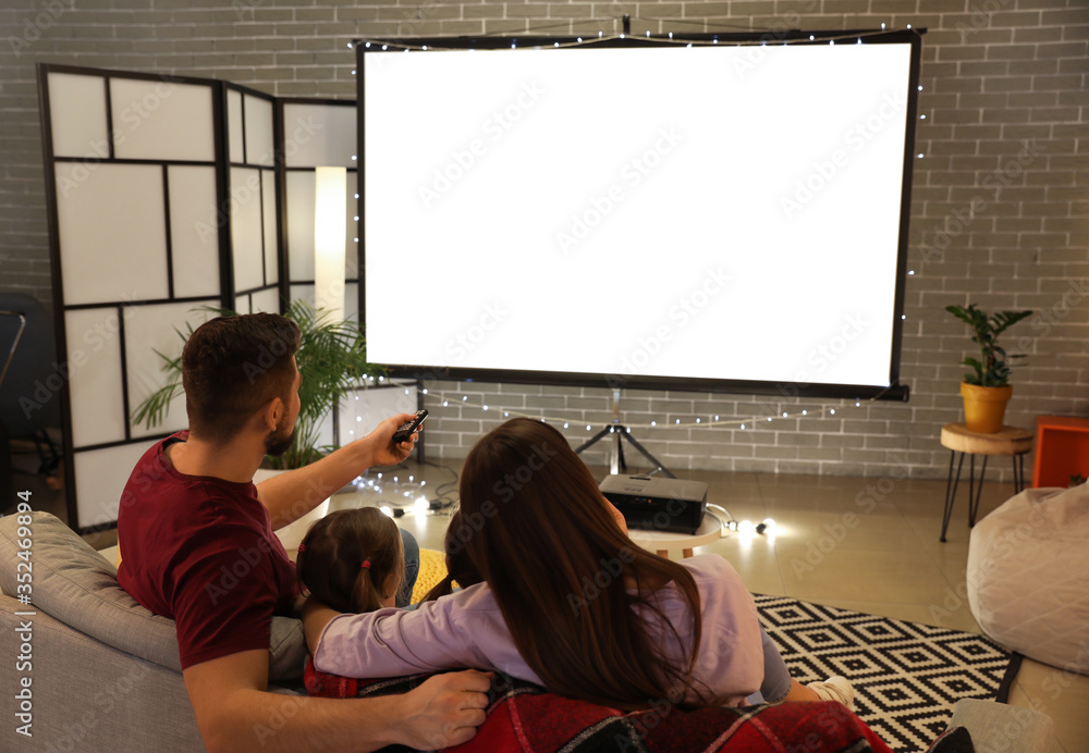 Young family watching movie at home