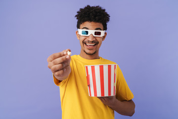 Canvas Print - Photo of african american man watching movie and eating popcorn