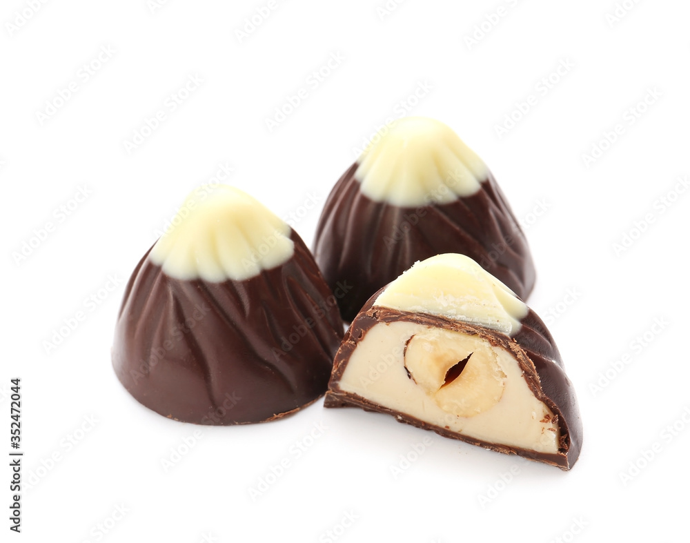 Tasty chocolate candies on white background