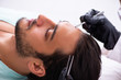 © Elnur - Young man visiting female beautician in hair transplantation con