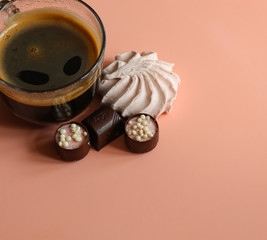 Cup of coffee, marshmallows and sweets close-up