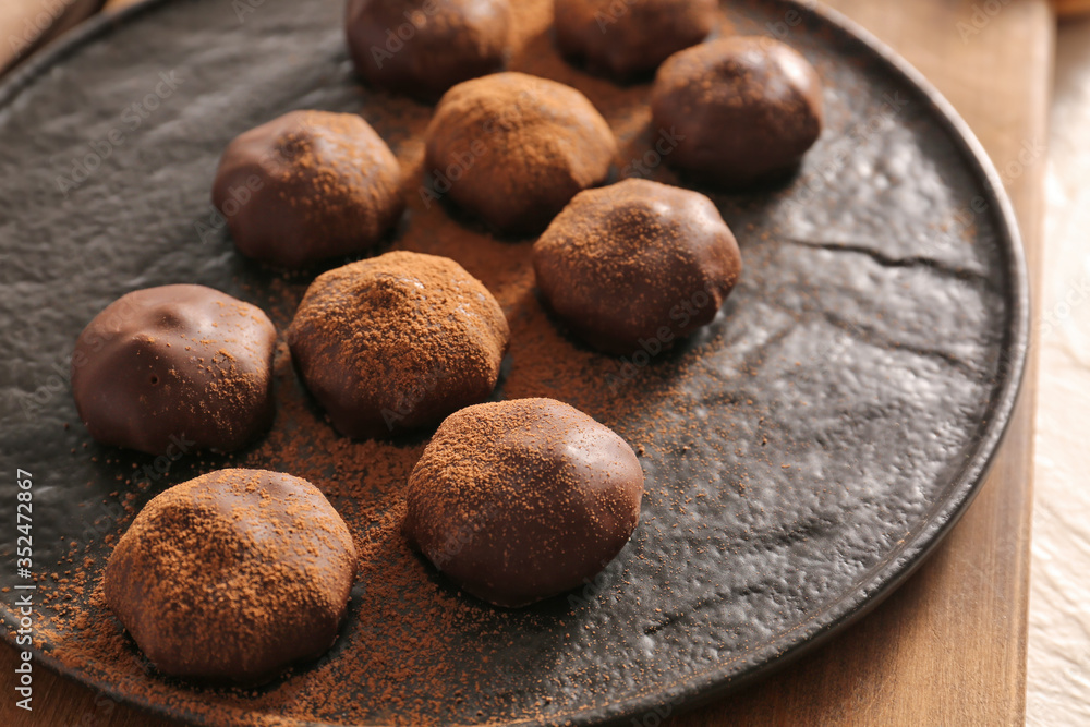 Plate with tasty chocolate candies, closeup