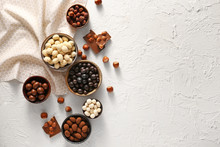 Different Tasty Chocolate Nuts On White Background