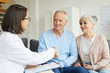 © Seventyfour - Portrait of smiling senior couple shaking hands with female doctor while visiting private clinic