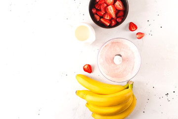 Healthy homemade smoothie or ice cream made from strawberries and banana. Top view with copy space.