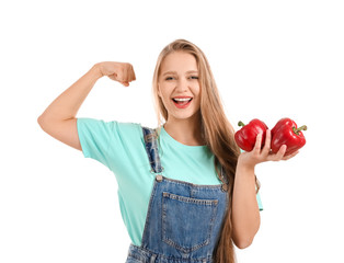 Wall Mural - Young woman with bell peppers on white background. Diet concept