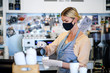 © Halfpoint - Coffee shop woman owner working with face mask, open after lockdown quarantine.