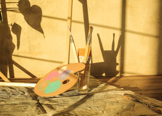 Detail of paiting tools on a warm sunny light