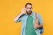 © ViDi Studio - Shocked young man student in casual clothes glasses with backpack hold books isolated on yellow background. Education in high school university college concept. Try to hear you with hand near ear.