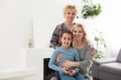 © Angelov - Portrait of three generations of women look at camera posing for family picture, cute little girl hug mom and granny enjoy time at home, smiling mother, daughter and grandmother spend weekend together