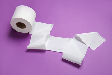 Roll of toilet paper on color background