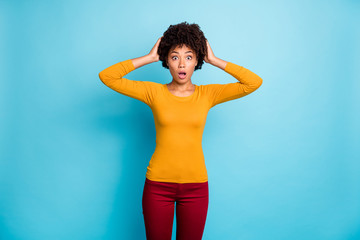 Canvas Print - Astonished afro american girl listen horrible information work mistake impressed confused stare stupor touch hands head scream wow omg wear good look jumper isolated blue color background