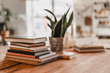 © Anastasia Gubinskaya - Stack of colorful books on wooden table in the room. Selective focus.