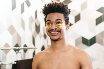 Poster - Photo of african american man with eye patches looking at mirror