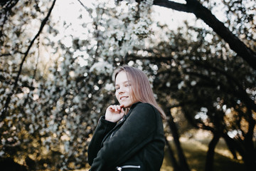 portrait of a cute girl in a flowered park.