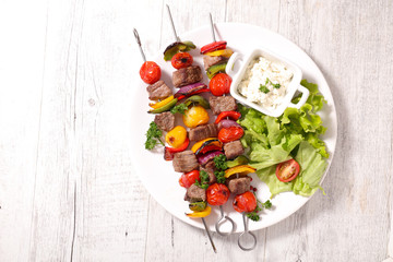 Sticker - grilled beef skewer with dip and salad