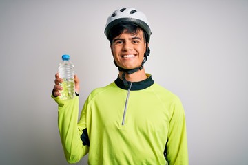 Poster - Young handsome cyclist man wearing security bike helmet drinking bottle of water with a happy face standing and smiling with a confident smile showing teeth