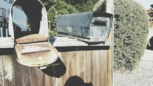 Old Rusty Mailboxes On Wooden Structure