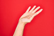 © Krakenimages.com - Hand of caucasian young man showing fingers over isolated red background presenting with open palm, reaching for support and help, assistance gesture