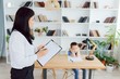 © Serhii - Picture of child psychologist working with young boy in office