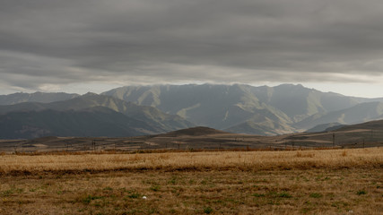 Mountains in Armenia with power line and overcast sky