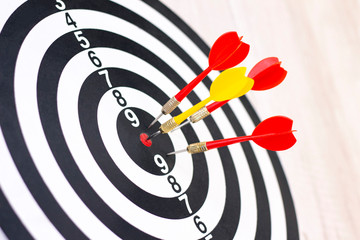 Dartboard with hit bullseye on white background, closeup. Bullseye is a business target. Target concept