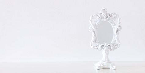 Wall Mural - Image of white vintage mirror over wooden table. For mockup, can be used for photography montage