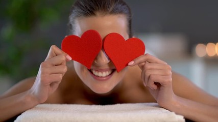 Canvas Print - Woman enjoying body massage at spa club and covering eyes with hearts