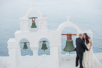 bride and groom posing  in city of santorini